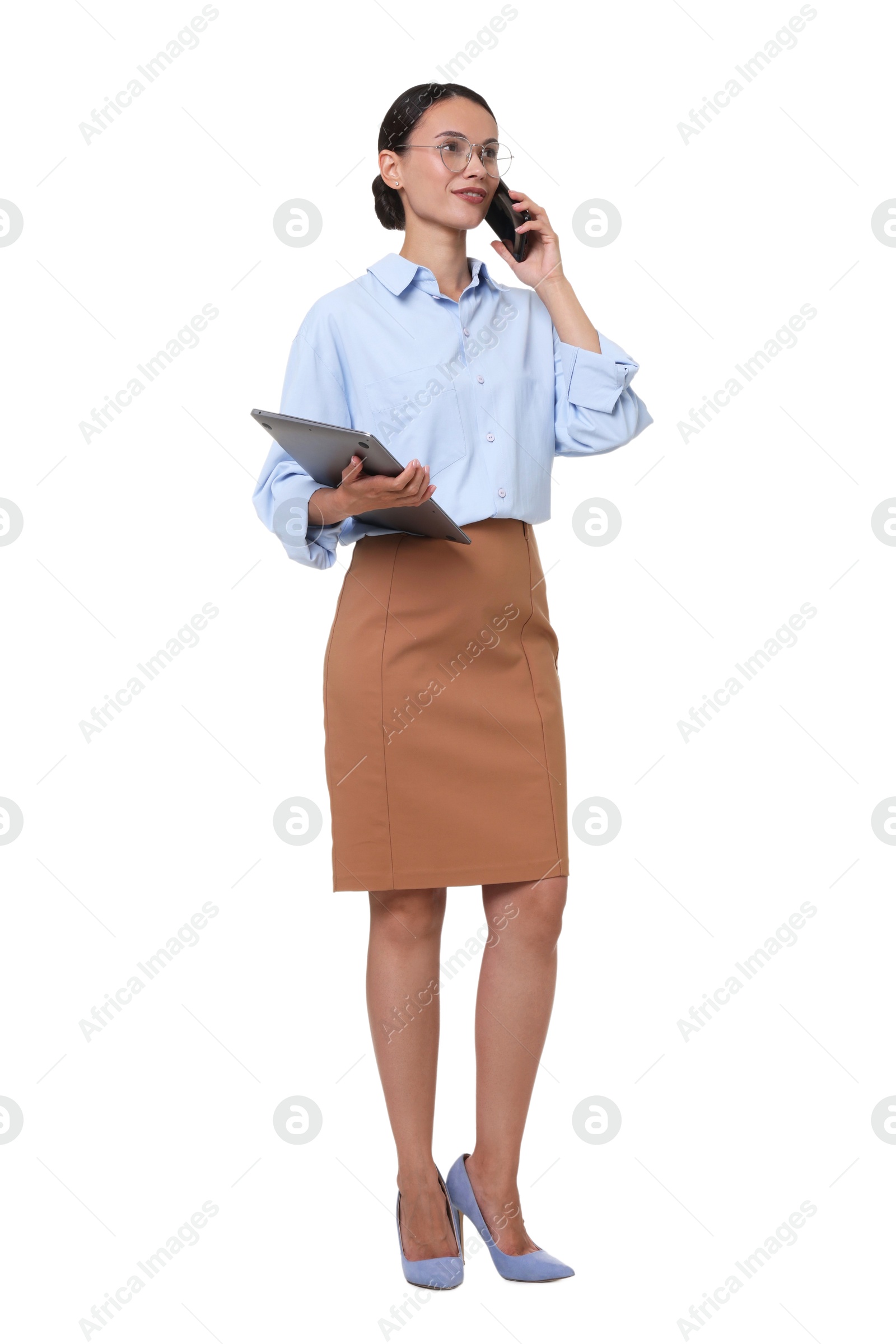 Smiling businesswoman in glasses with laptop talking by smartphone on white background Photo of Smiling businesswoman in glasses with laptop talking by smartphone on white background