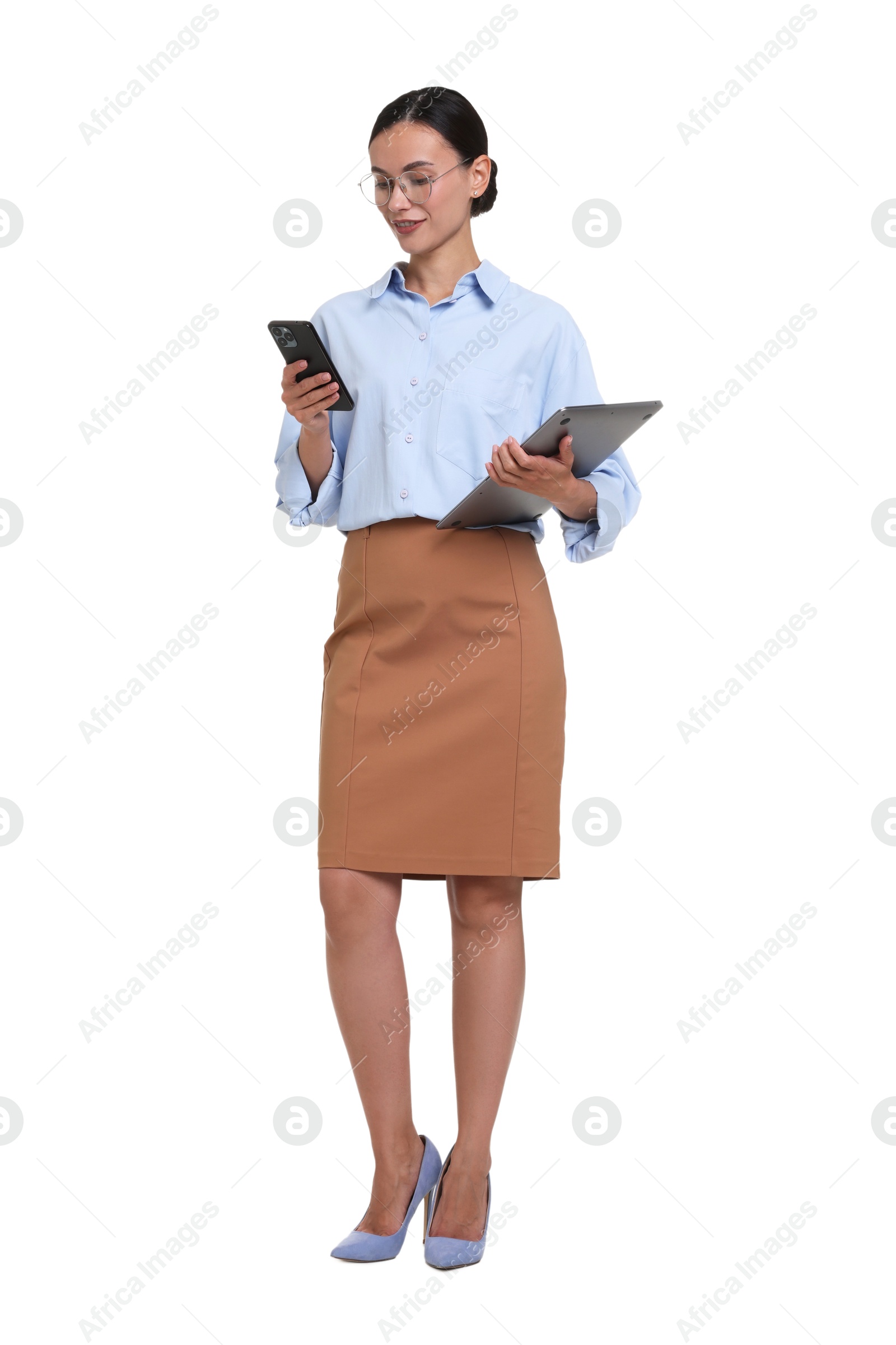 Photo of Smiling businesswoman in glasses with laptop talking by smartphone on white background