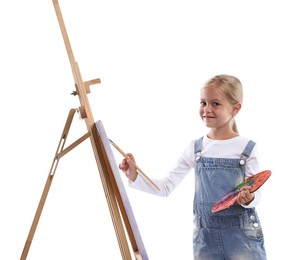 Photo of Choice of profession. Little girl with palette of paints and brush near easel pretending to be artist on white background