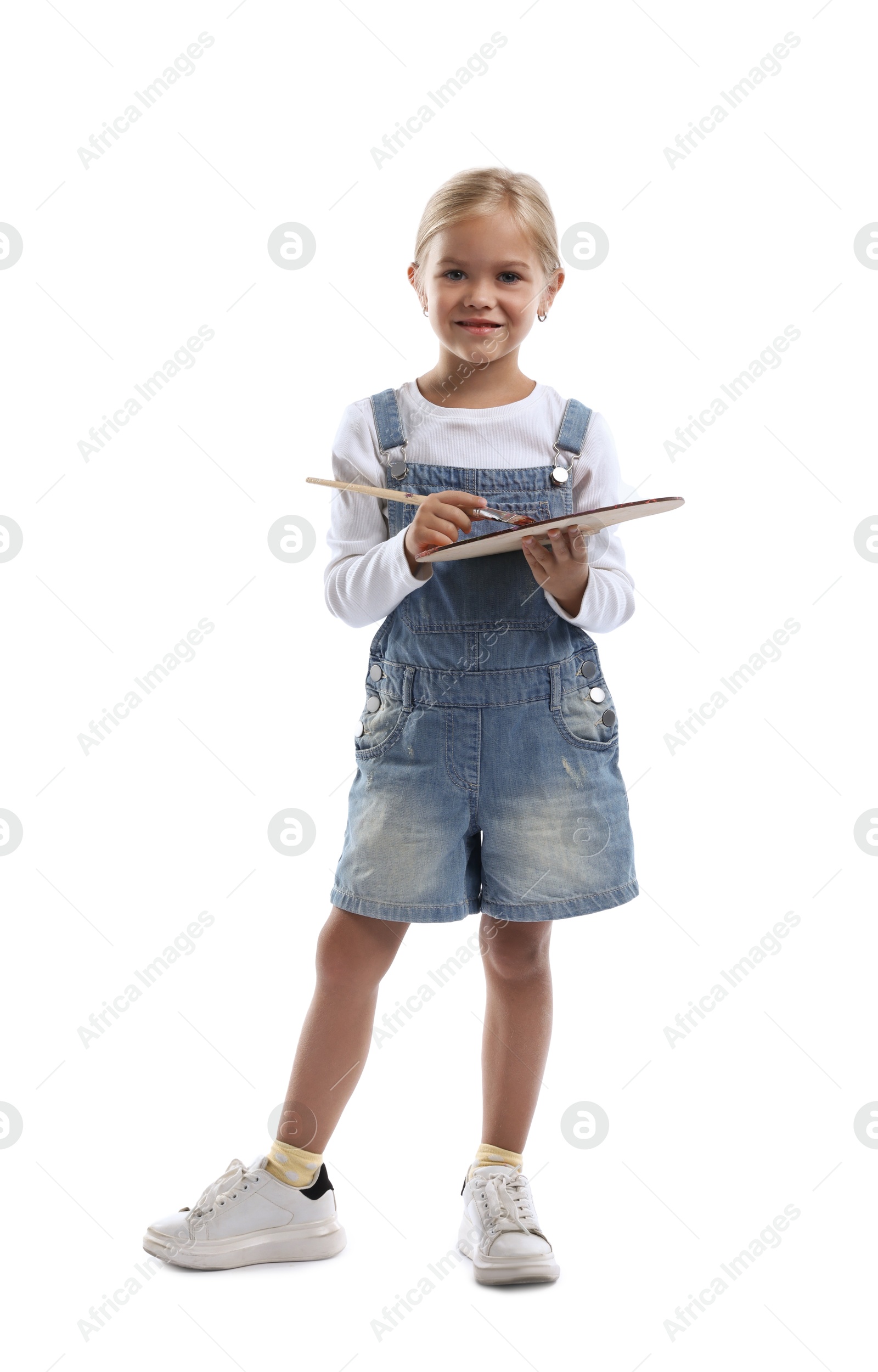 Photo of Choice of profession. Little girl with palette of paints and brush pretending to be artist on white background