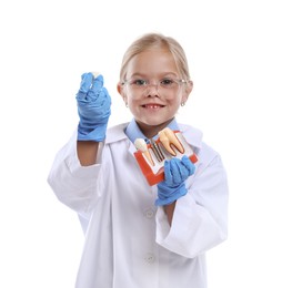 Photo of Choice of profession. Little girl with dental model pretending to be dentist on white background