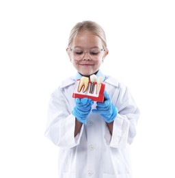 Photo of Choice of profession. Little girl with dental model pretending to be dentist on white background