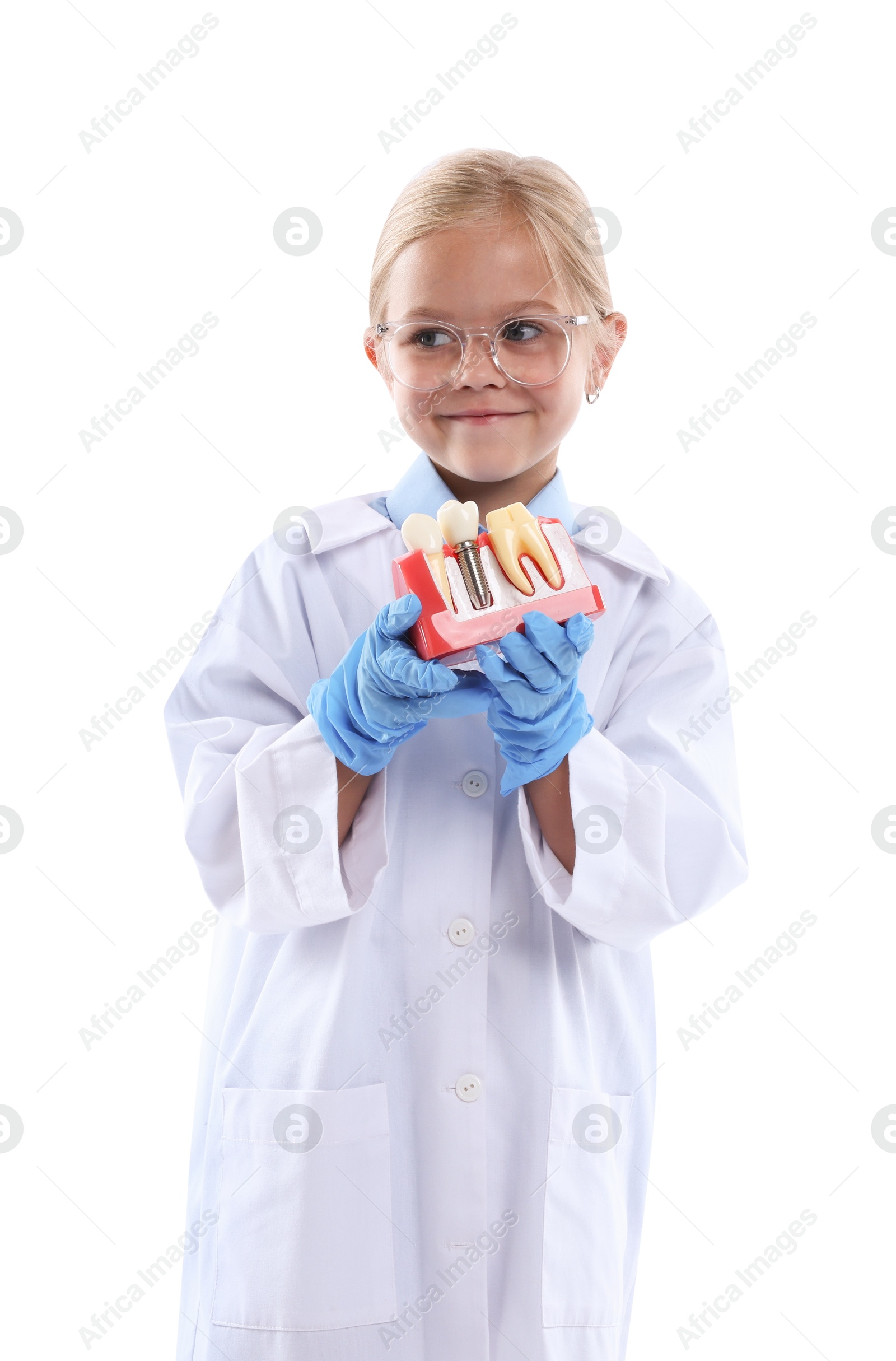 Photo of Choice of profession. Little girl with dental model pretending to be dentist on white background