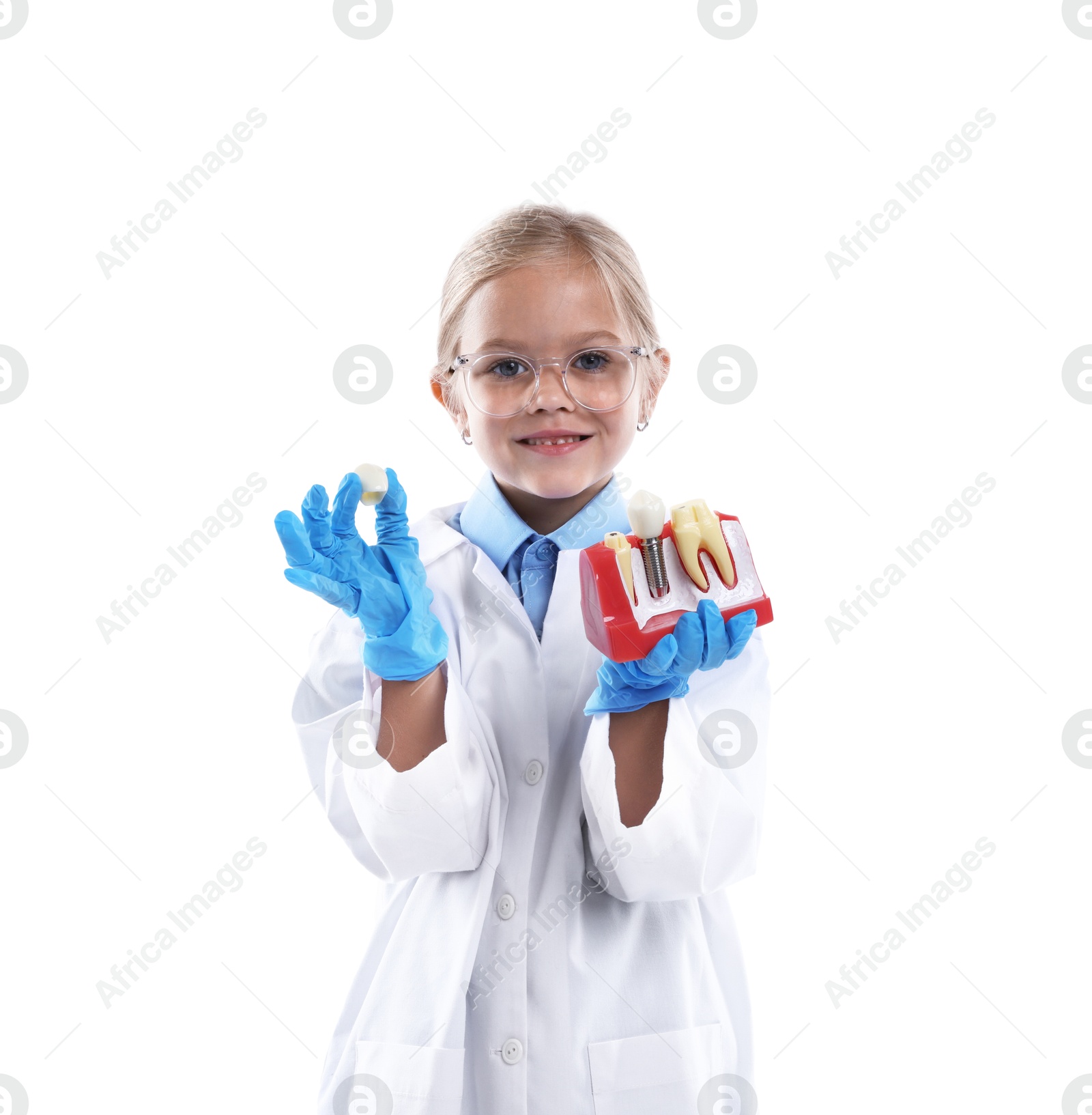 Photo of Choice of profession. Little girl with dental model pretending to be dentist on white background
