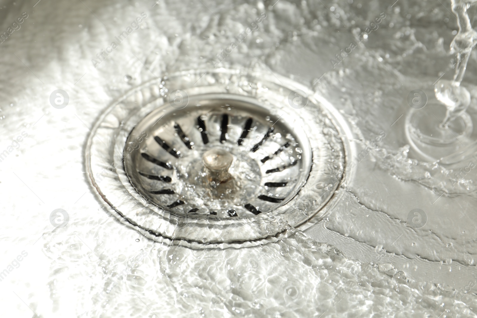 Water going down sink drain, closeup view Photo of Water going down sink drain, closeup view