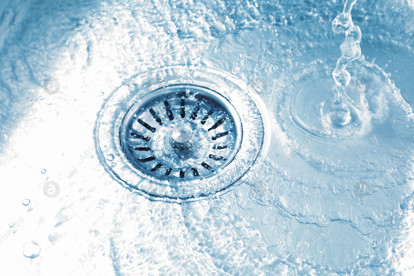 Water going down sink drain, closeup view Photo of Water going down sink drain, closeup view