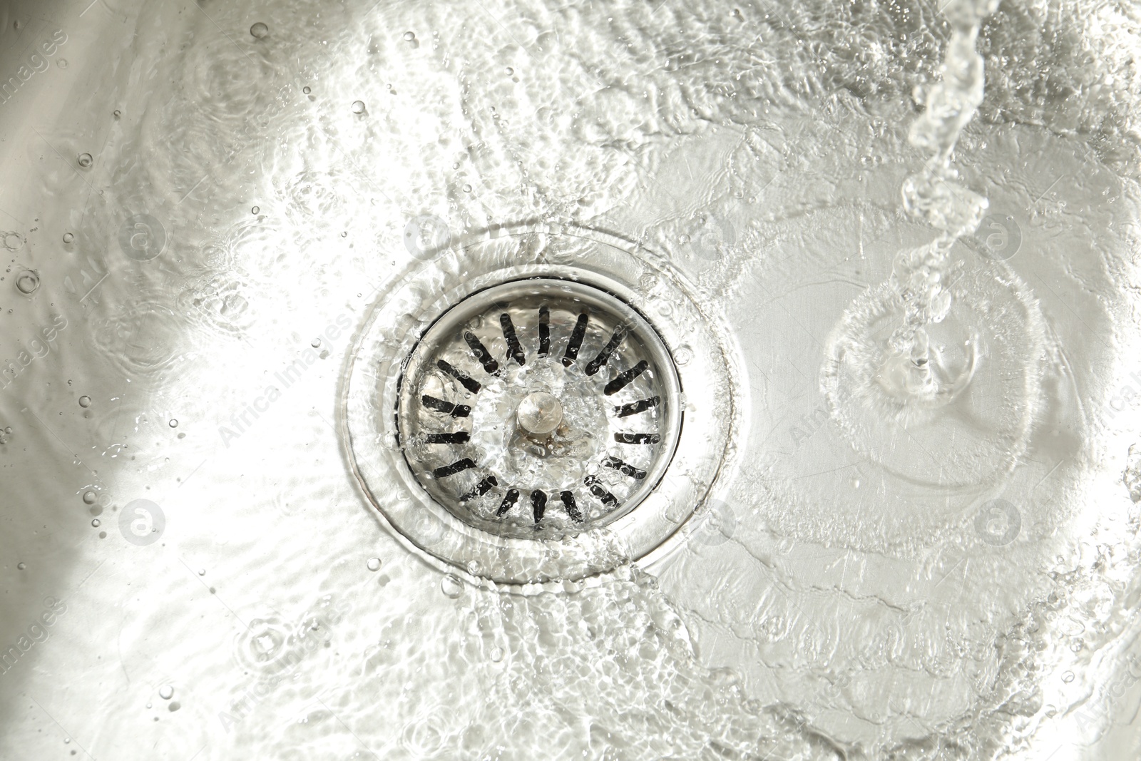 Water going down sink drain, closeup view Photo of Water going down sink drain, closeup view