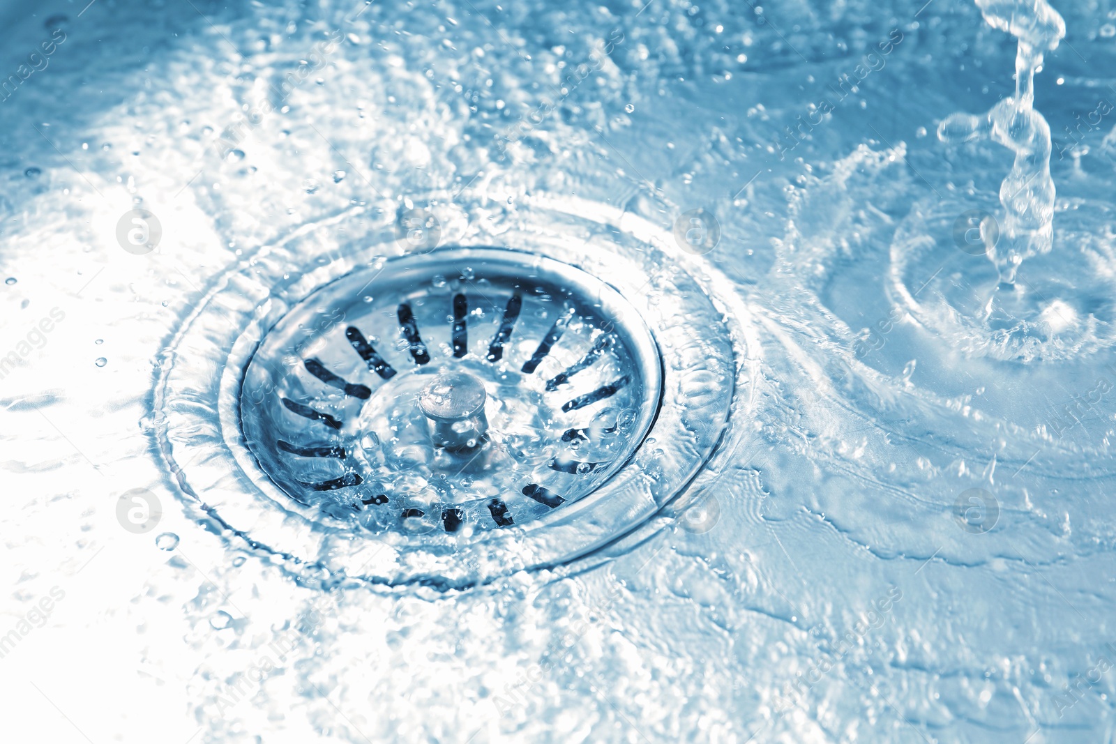 Water going down sink drain, closeup view Photo of Water going down sink drain, closeup view