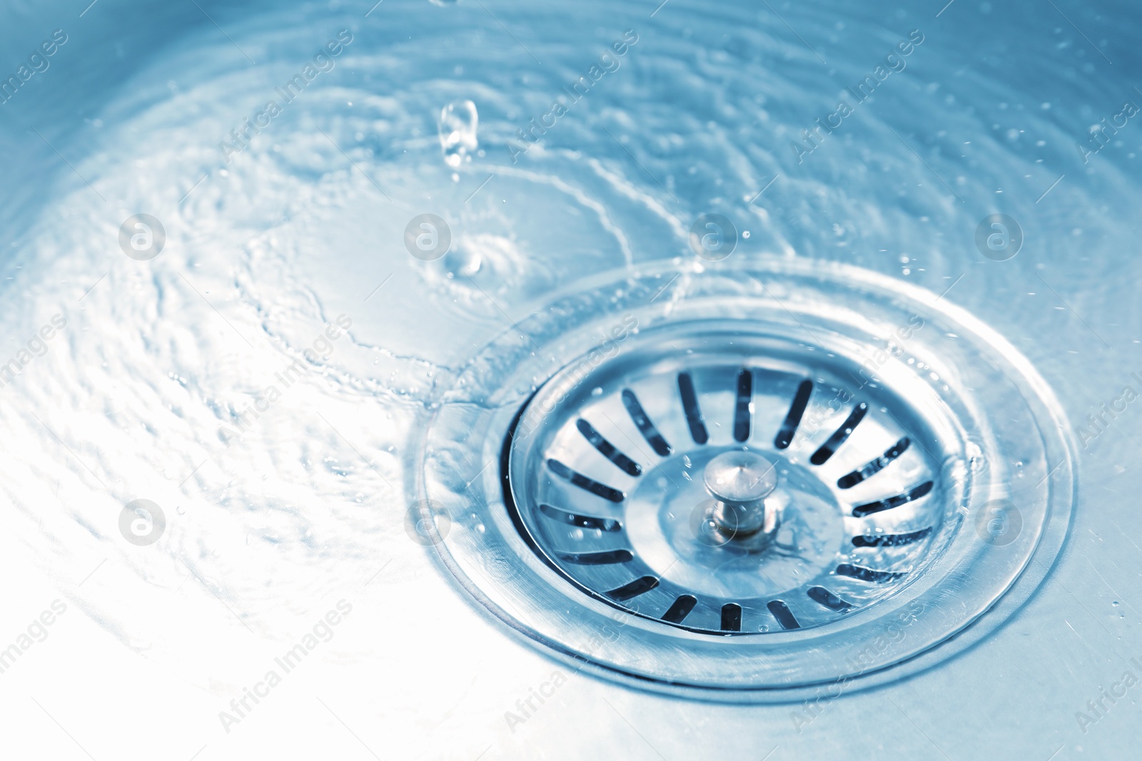 Water going down sink drain, closeup view Photo of Water going down sink drain, closeup view