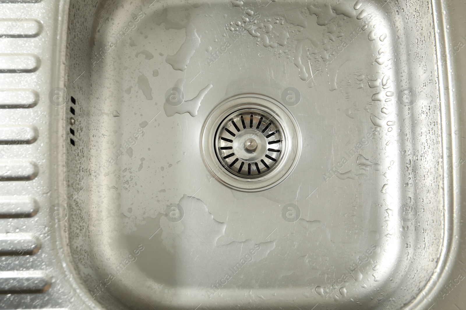 Photo of Water going down sink drain, top view
