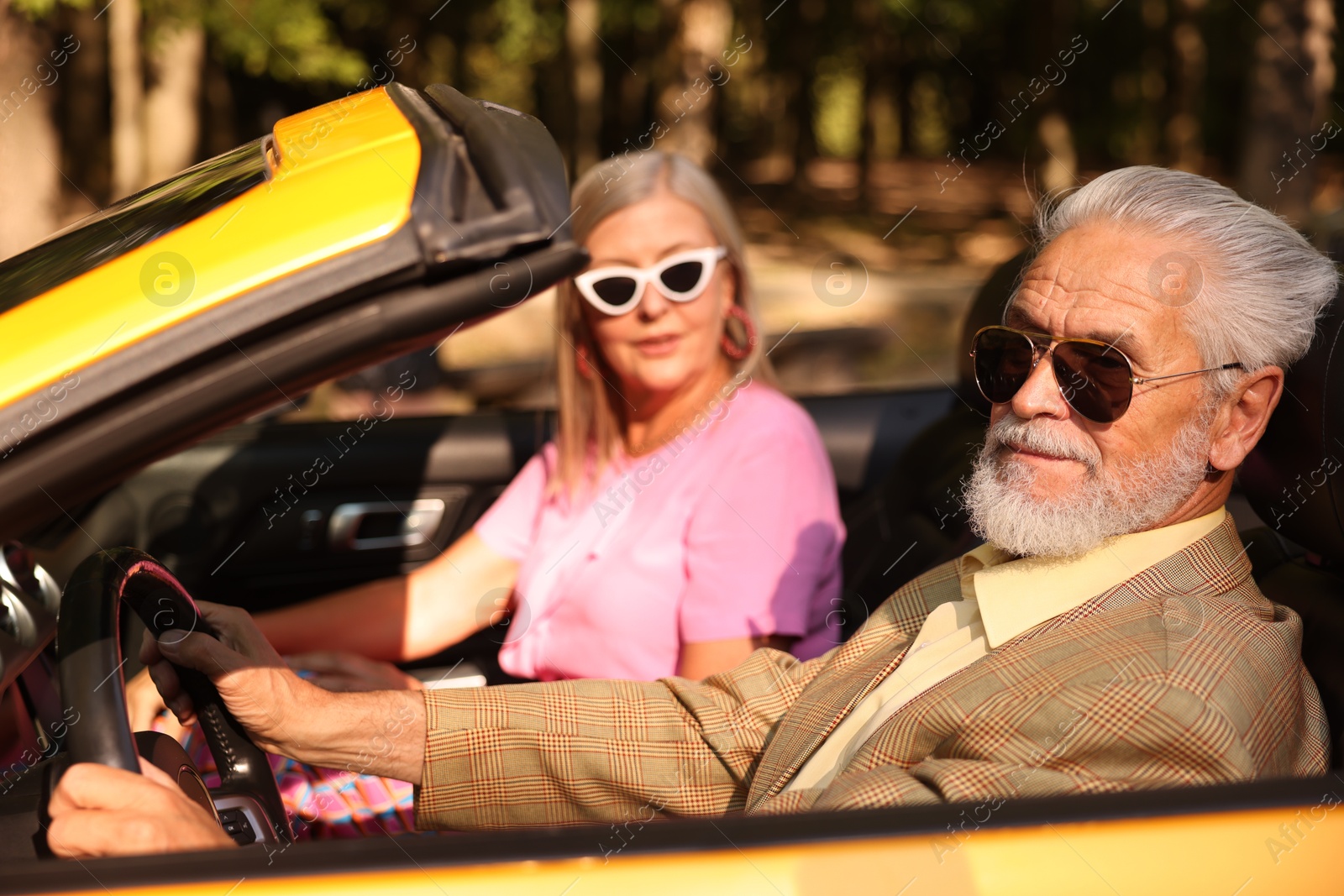 Senior couple enjoying cabriolet ride in city, selective focus Photo of Senior couple enjoying cabriolet ride in city, selective focus