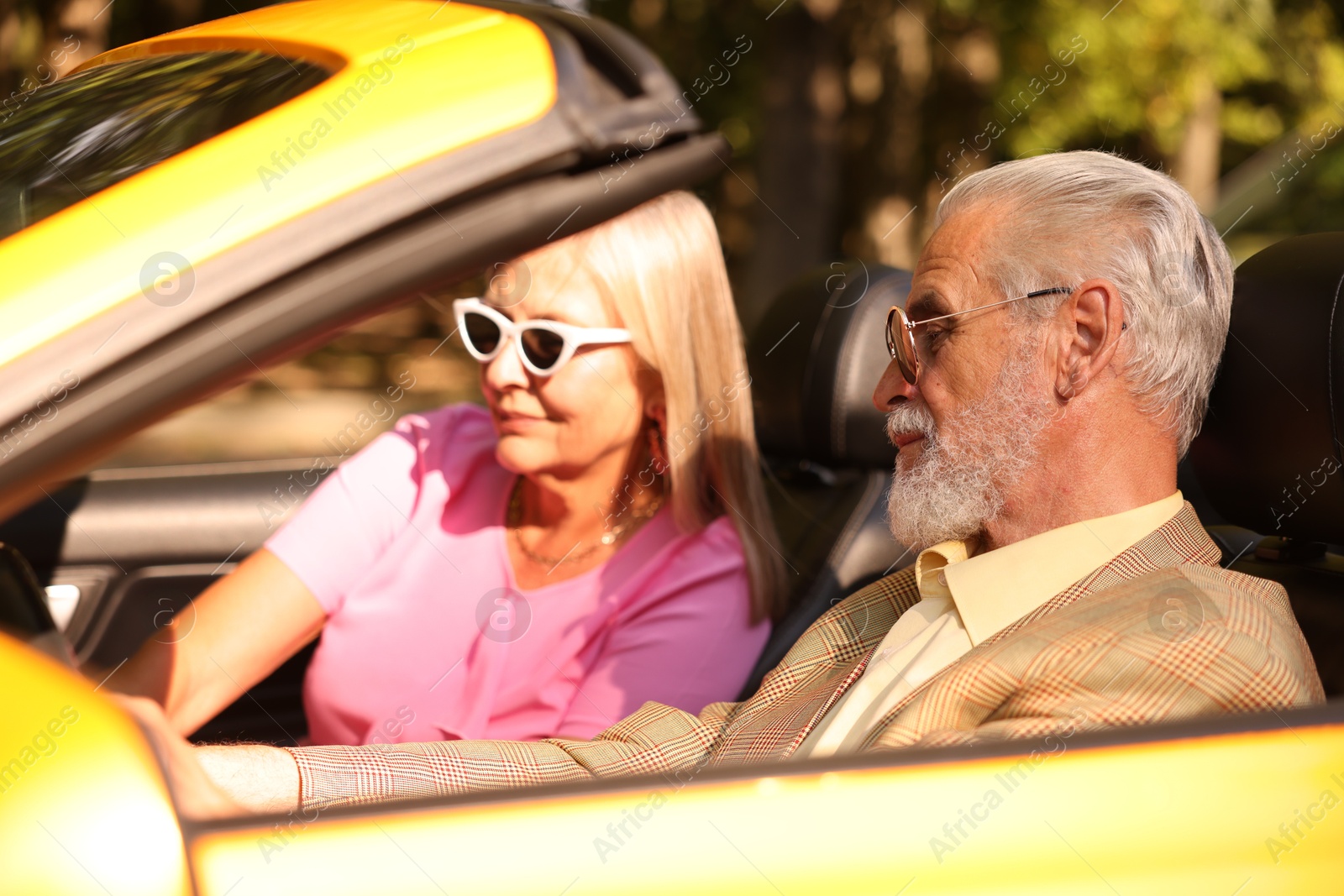 Senior couple enjoying cabriolet ride in city, selective focus Photo of Senior couple enjoying cabriolet ride in city, selective focus