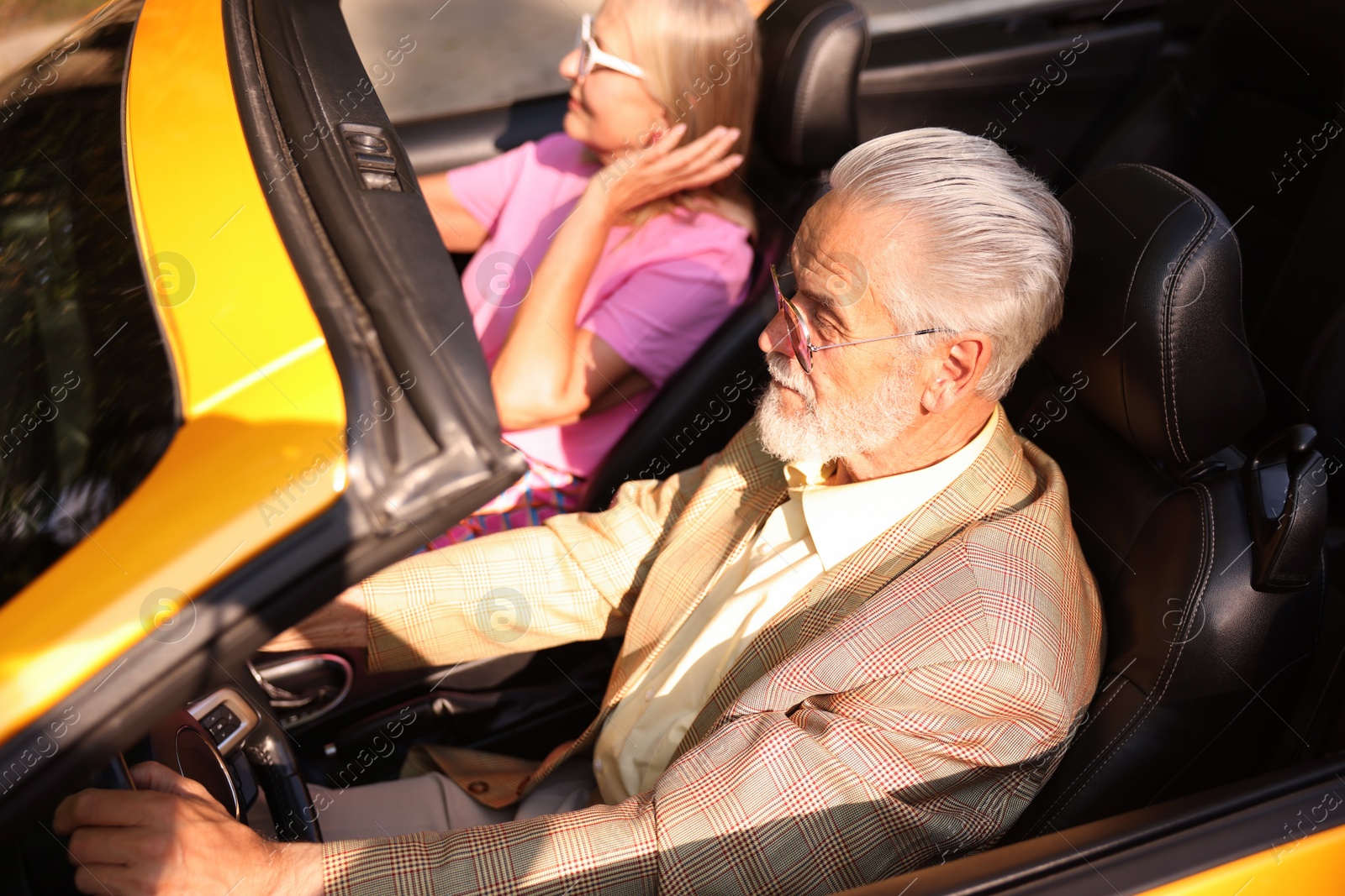 Senior couple enjoying cabriolet ride in city, selective focus Photo of Senior couple enjoying cabriolet ride in city, selective focus