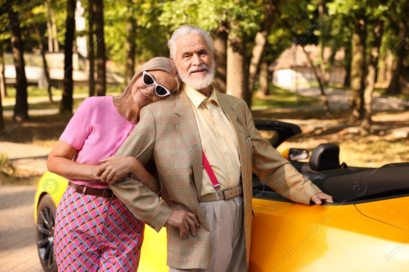 Photo of Stylish senior couple near modern cabriolet outdoors