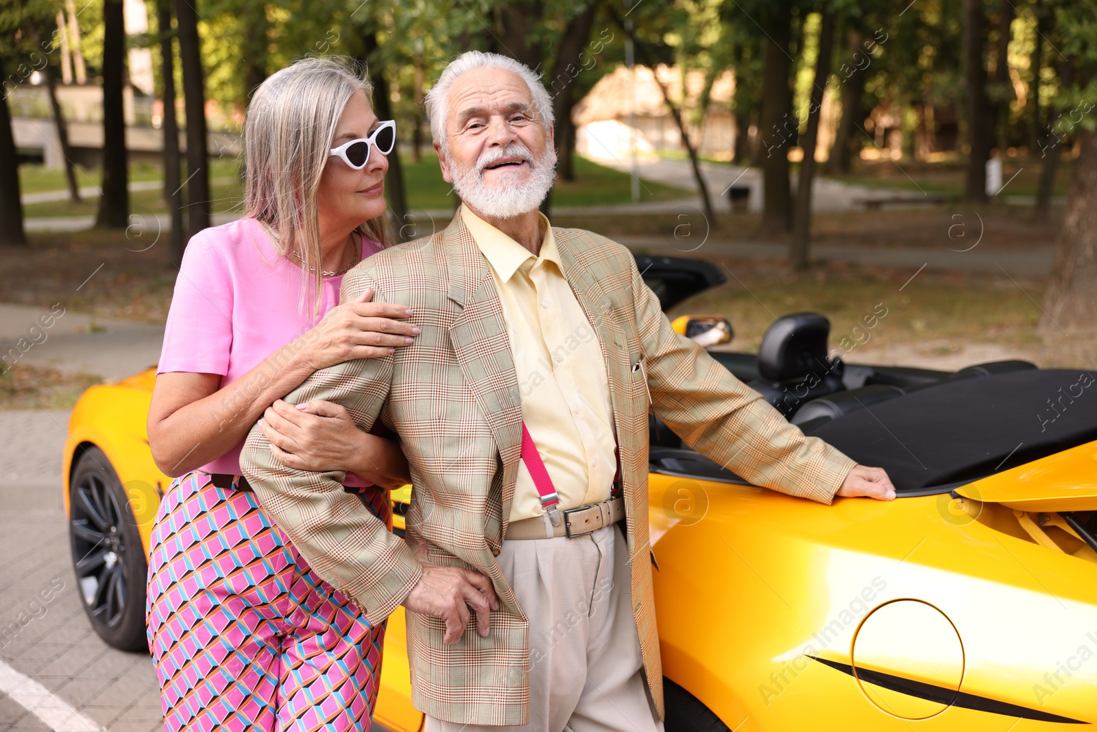Photo of Stylish senior couple near modern cabriolet outdoors