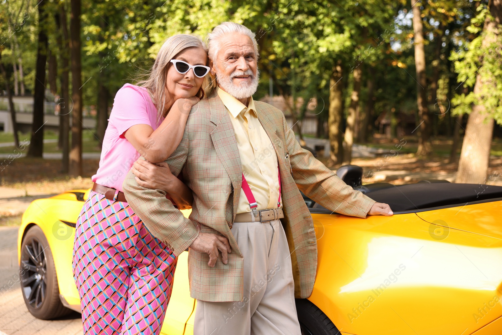 Photo of Stylish senior couple near modern cabriolet outdoors