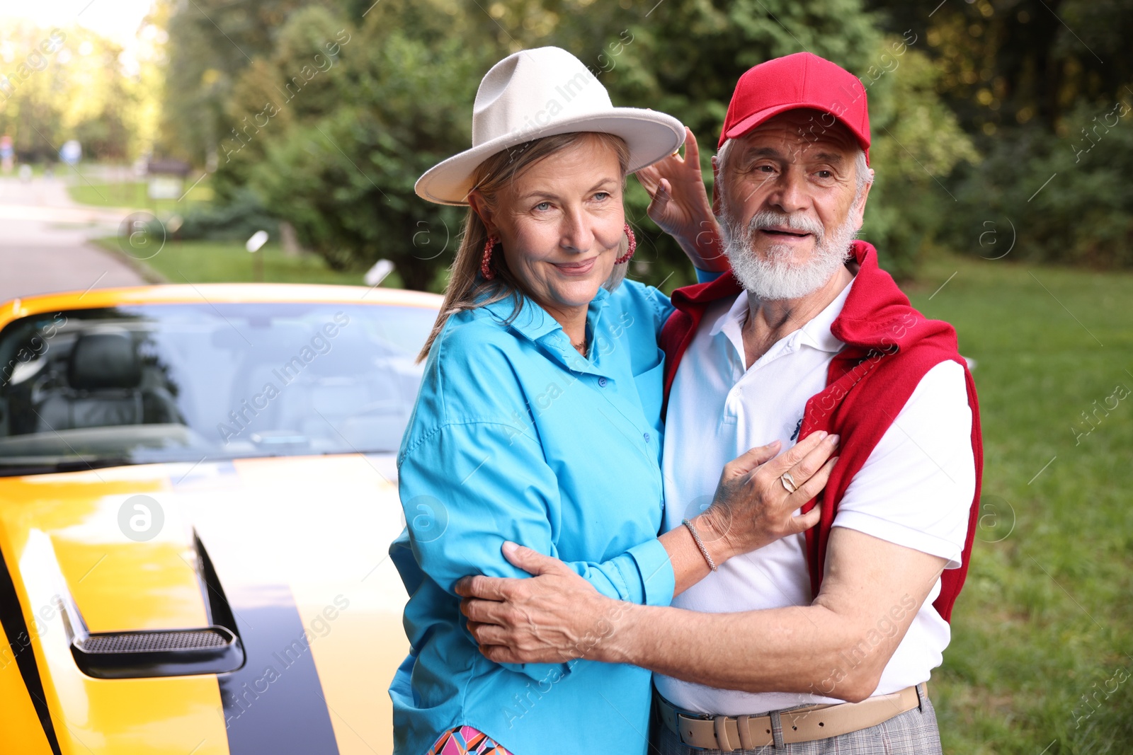 Photo of Stylish senior couple near modern cabriolet outdoors