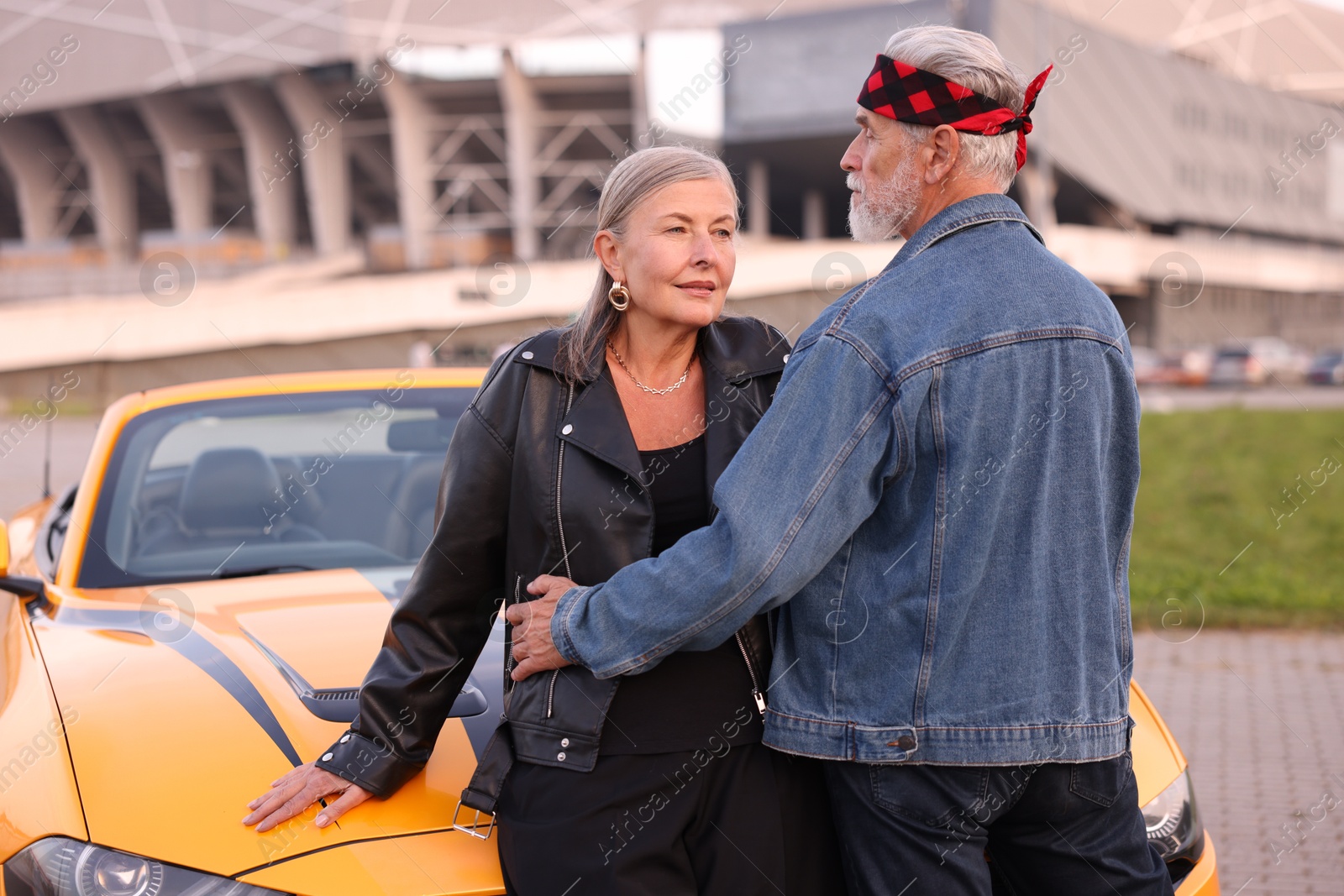 Photo of Stylish senior couple near modern cabriolet outdoors