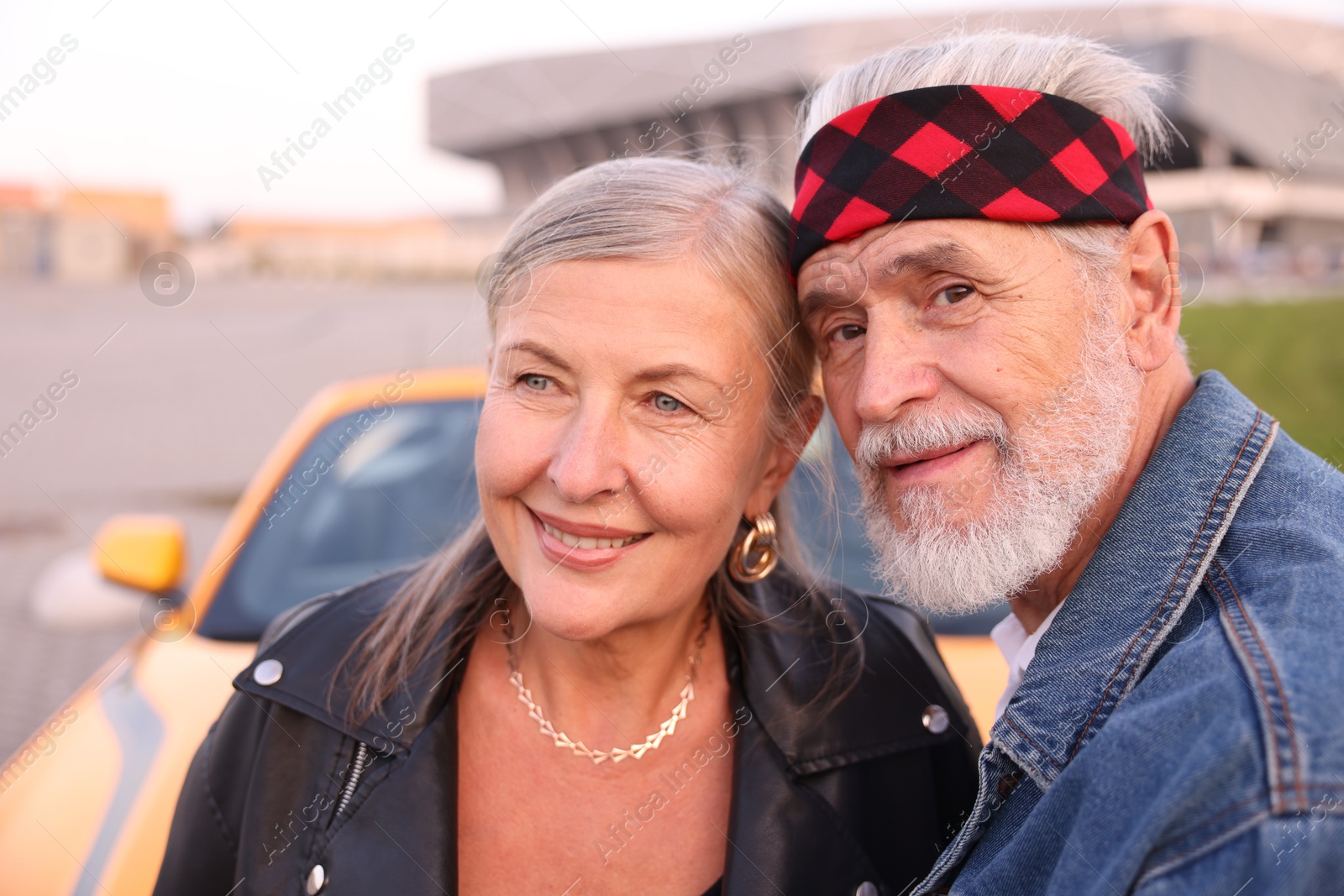 Photo of Stylish senior couple near modern cabriolet outdoors