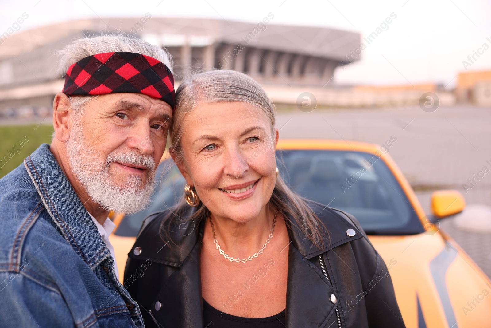 Photo of Stylish senior couple near modern cabriolet outdoors