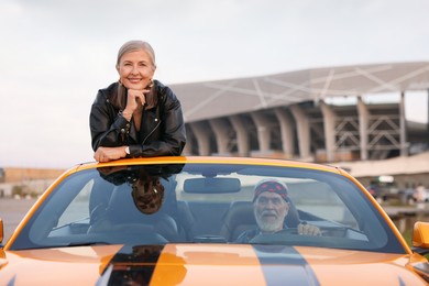 Photo of Senior couple enjoying cabriolet ride in city