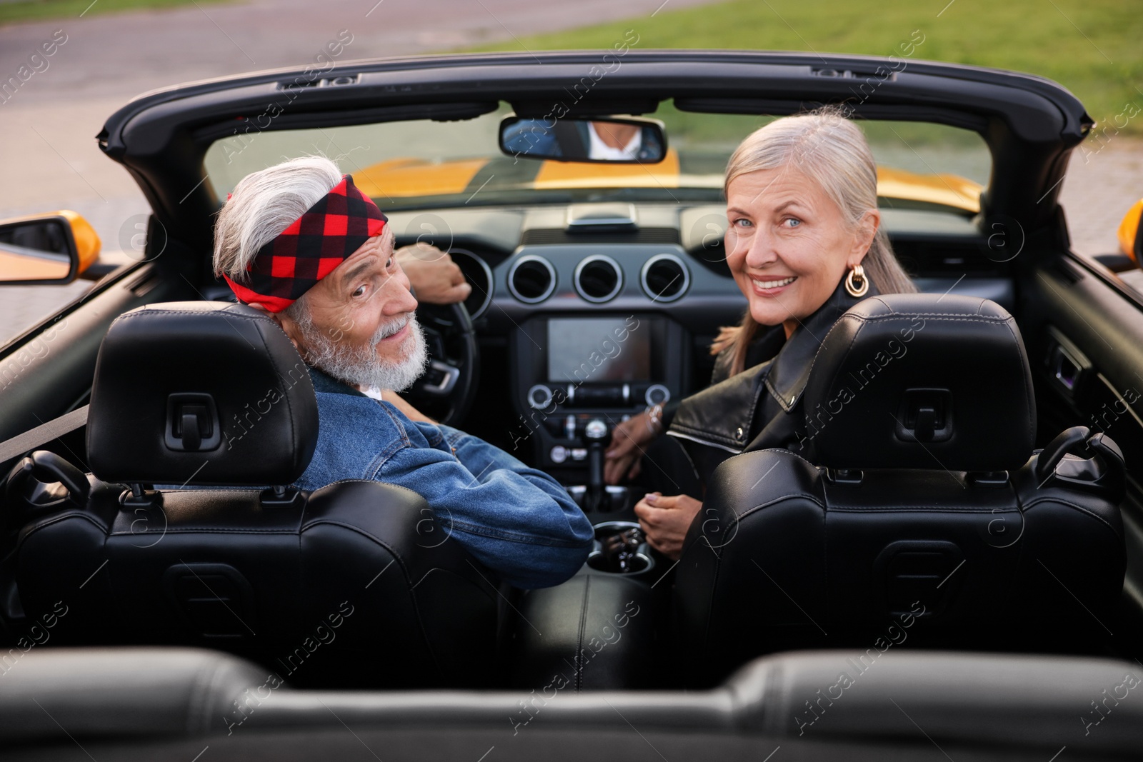 Stylish senior couple in modern cabriolet outdoors Photo of Stylish senior couple in modern cabriolet outdoors