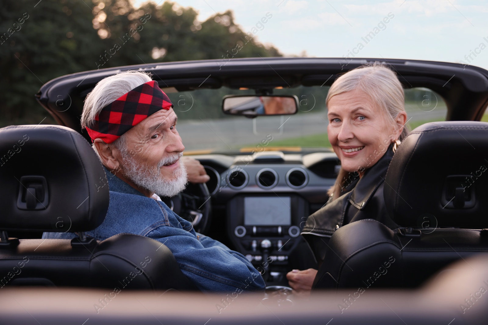 Photo of Stylish senior couple in modern cabriolet outdoors