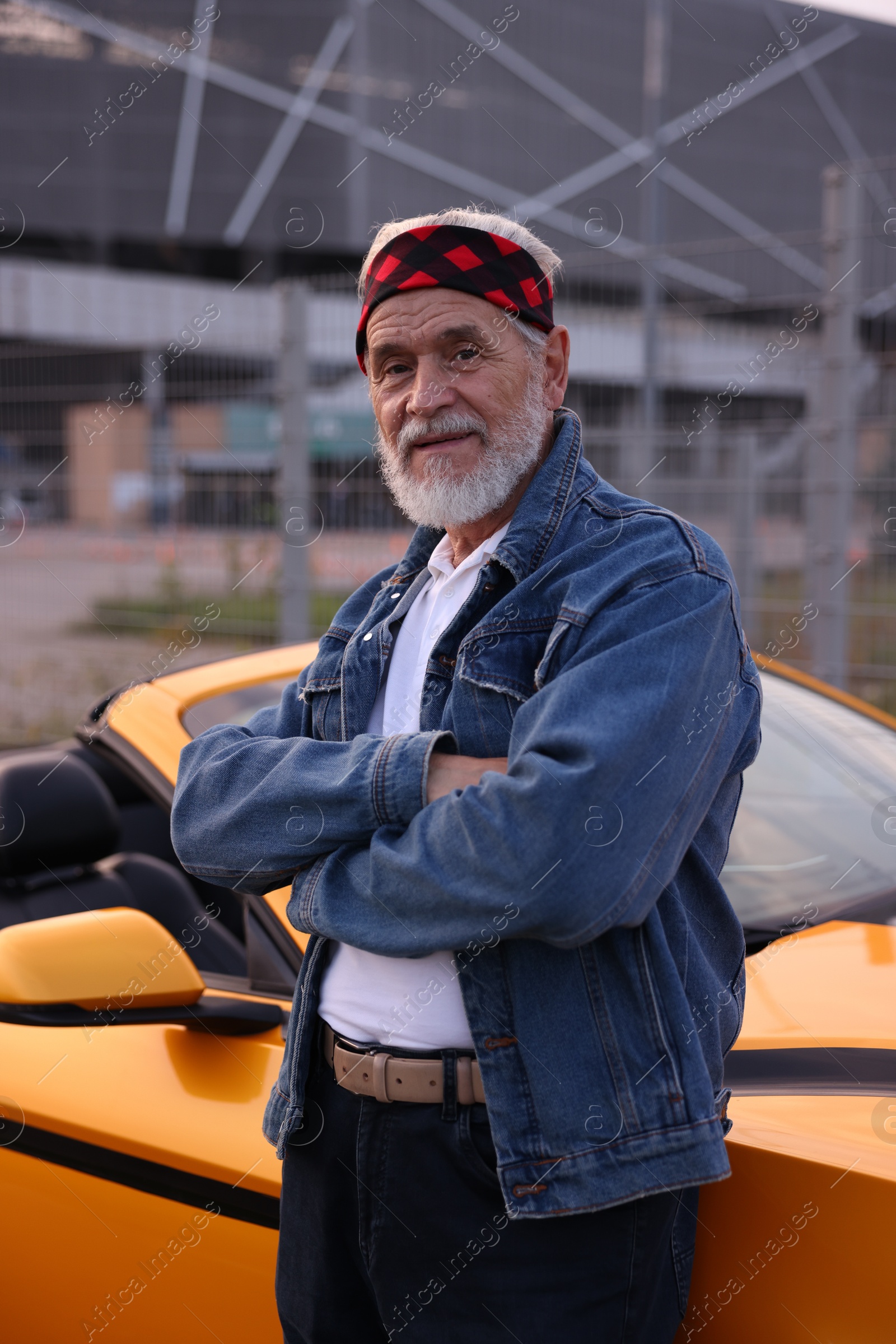 Photo of Stylish senior man near modern cabriolet outdoors