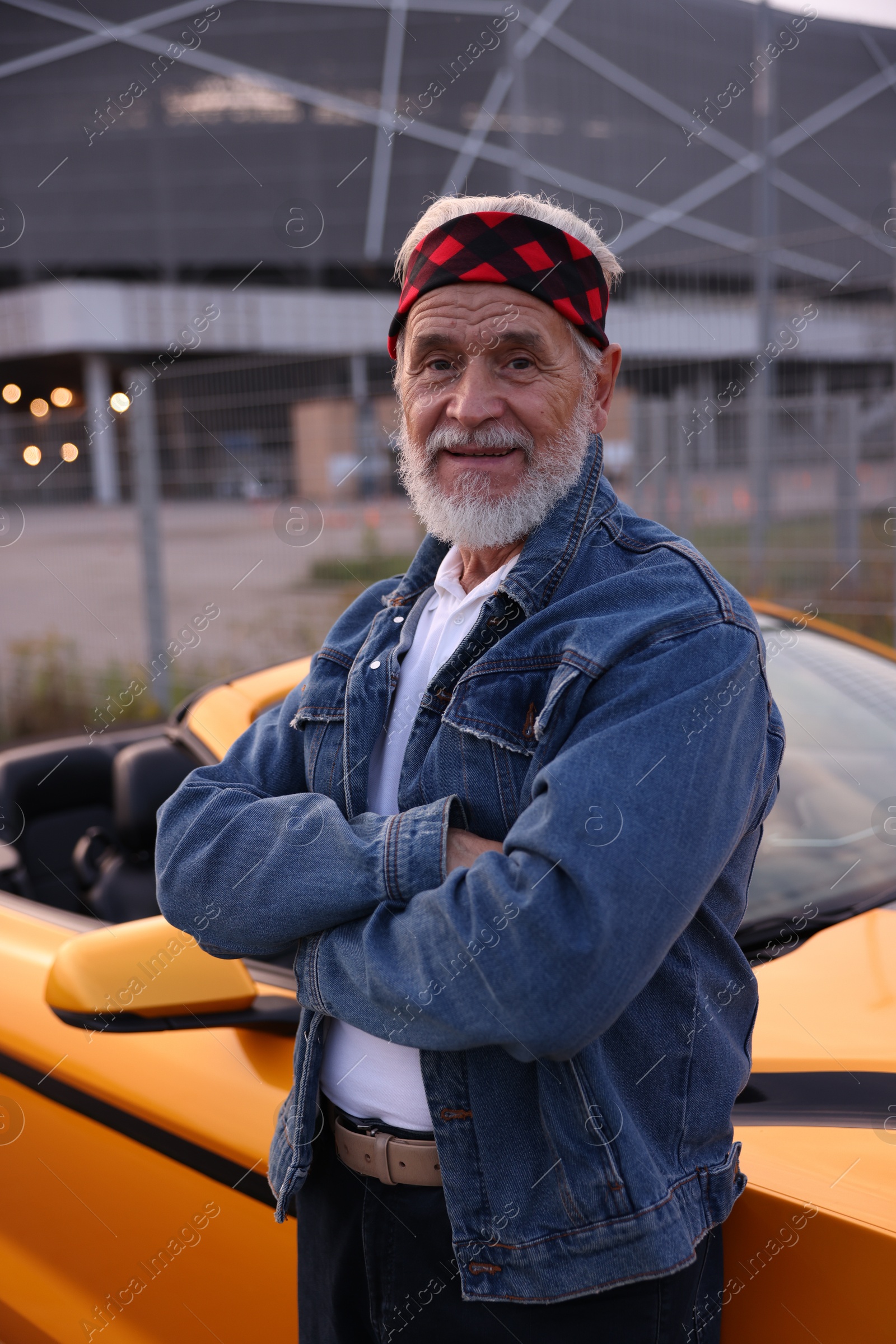 Photo of Stylish senior man near modern cabriolet outdoors
