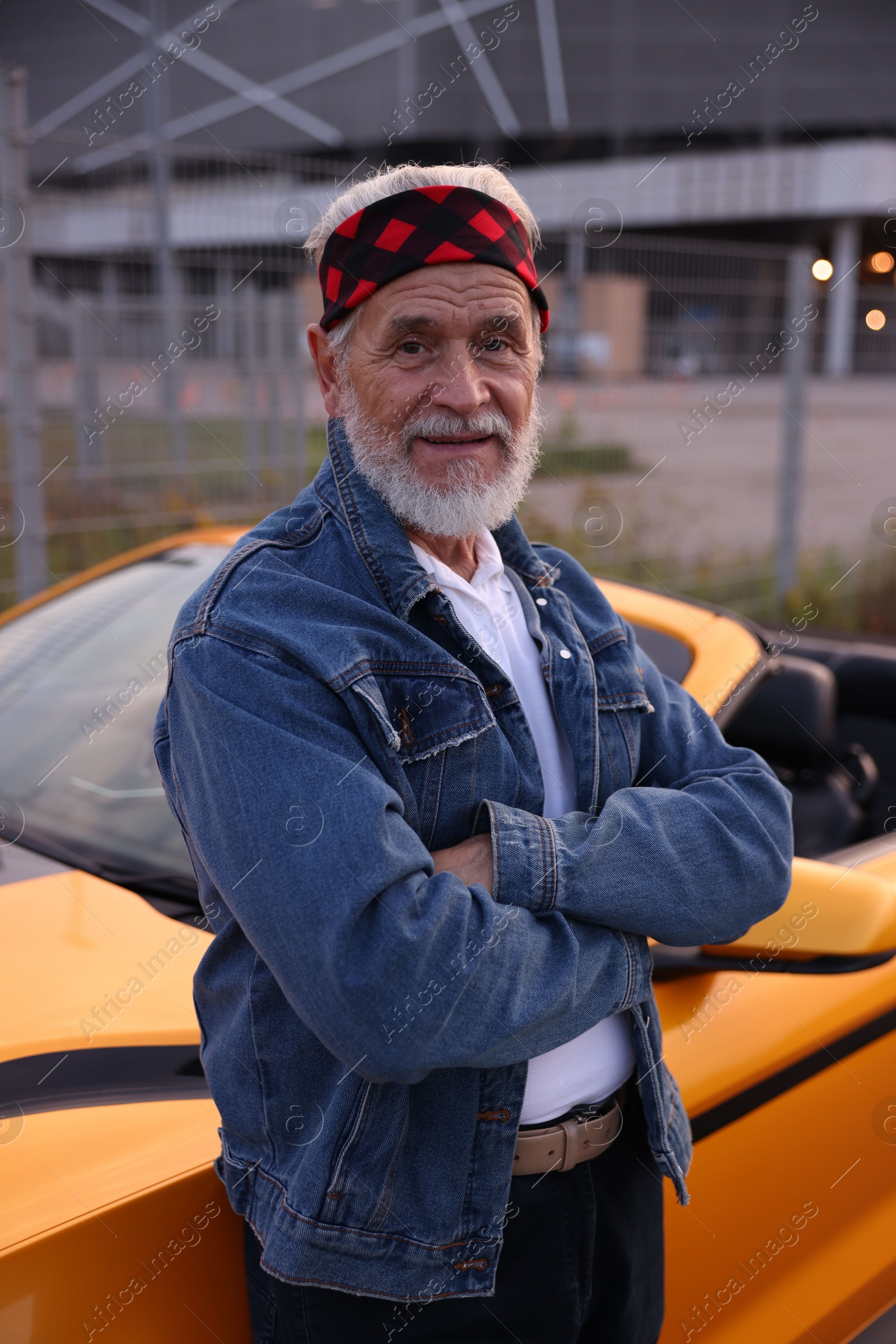 Photo of Stylish senior man near modern cabriolet outdoors