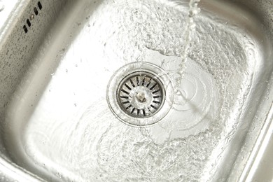 Photo of Water going down sink drain, above view