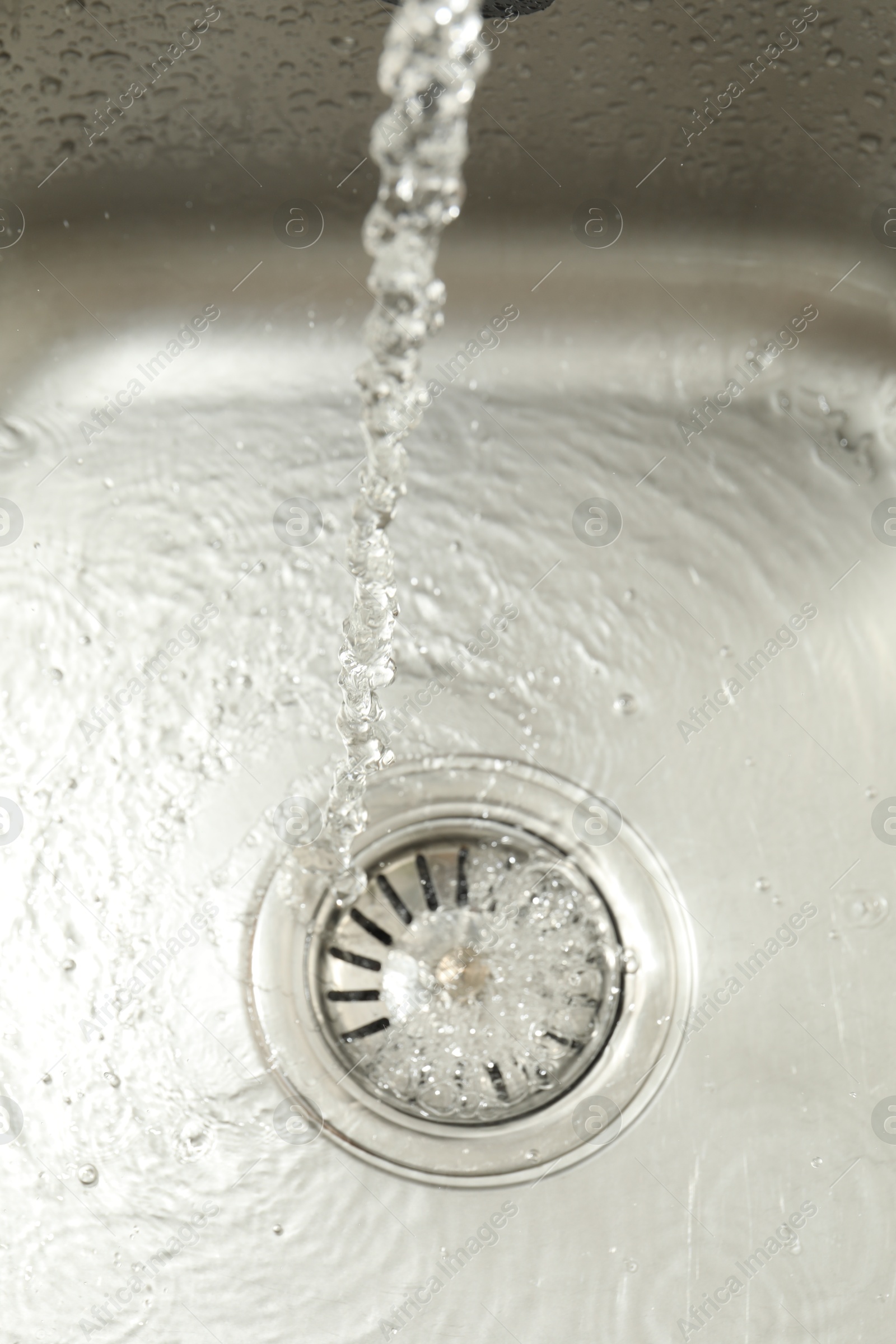 Photo of Water going down sink drain, above view