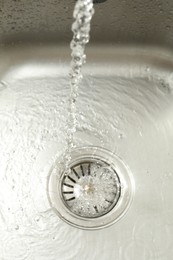 Photo of Water going down sink drain, above view
