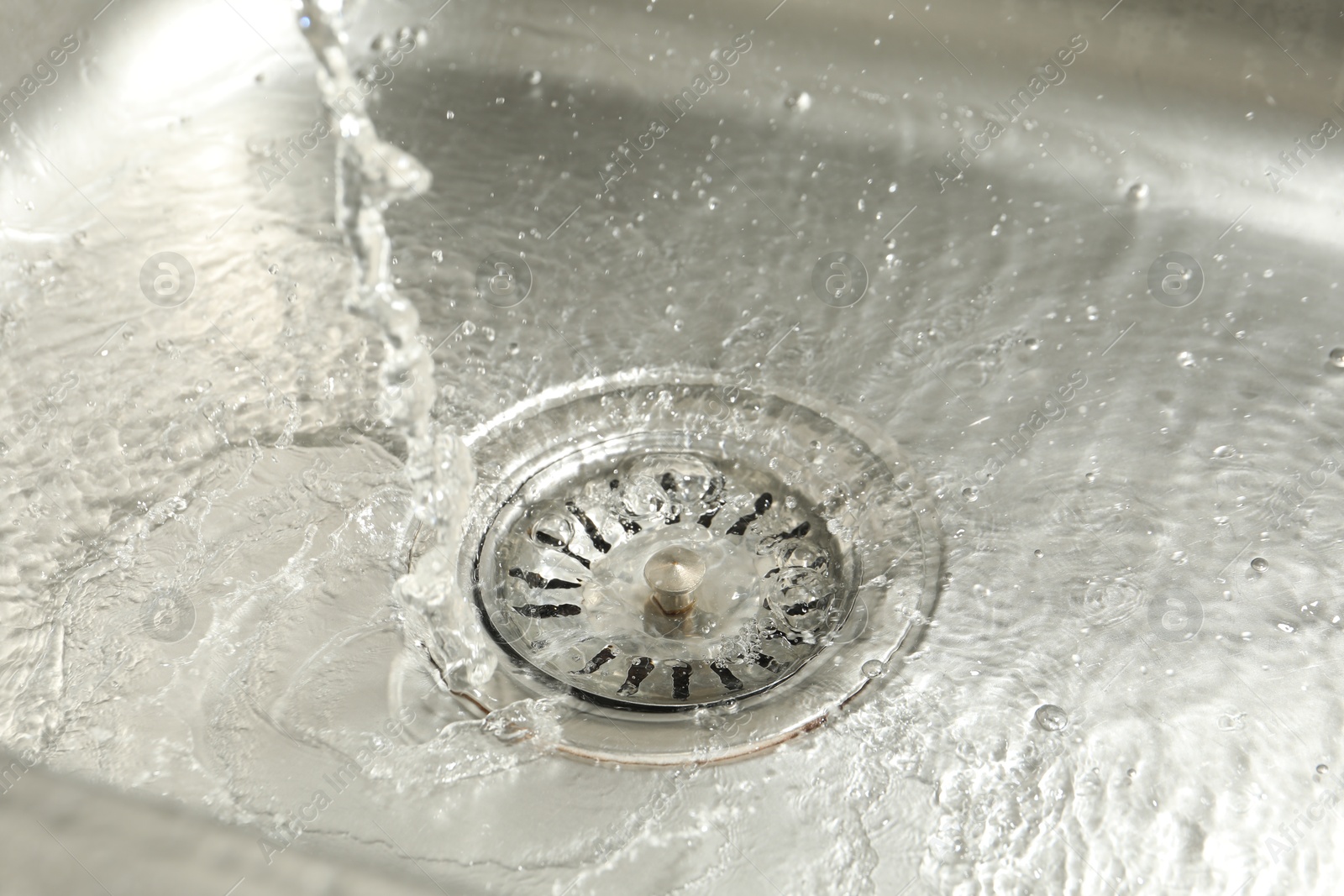 Water going down sink drain, closeup view Photo of Water going down sink drain, closeup view