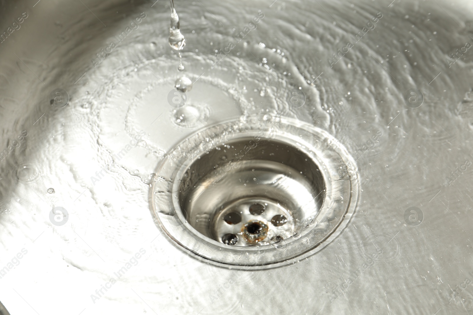 Water going down sink drain, closeup view Photo of Water going down sink drain, closeup view