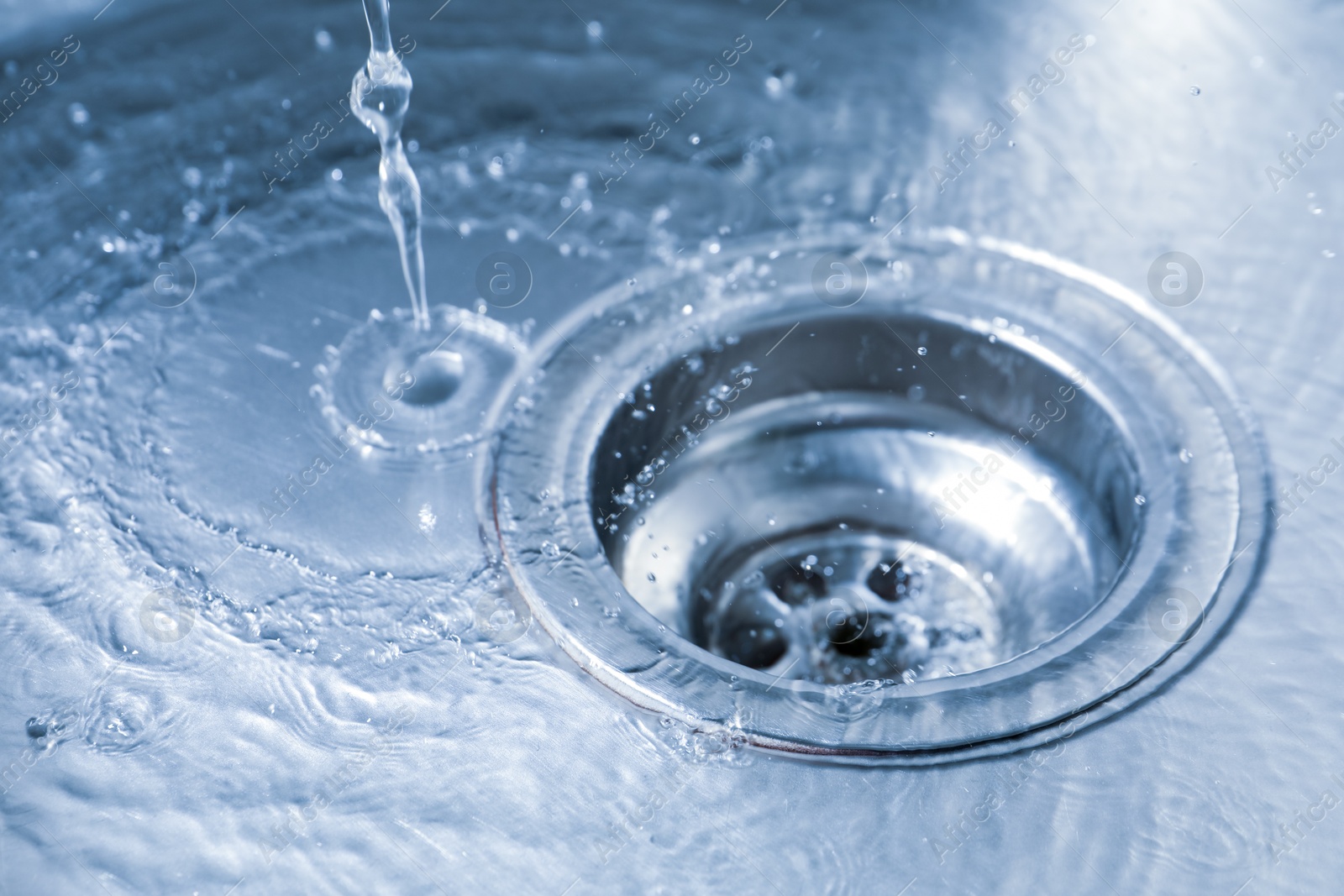 Water going down sink drain, closeup view Photo of Water going down sink drain, closeup view
