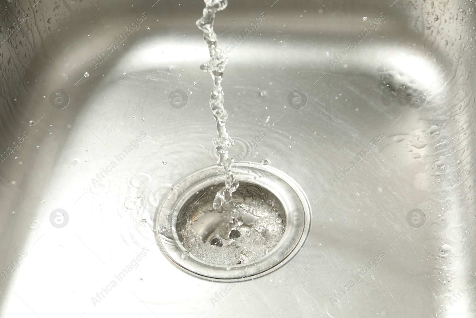 Water going down sink drain, closeup view Photo of Water going down sink drain, closeup view