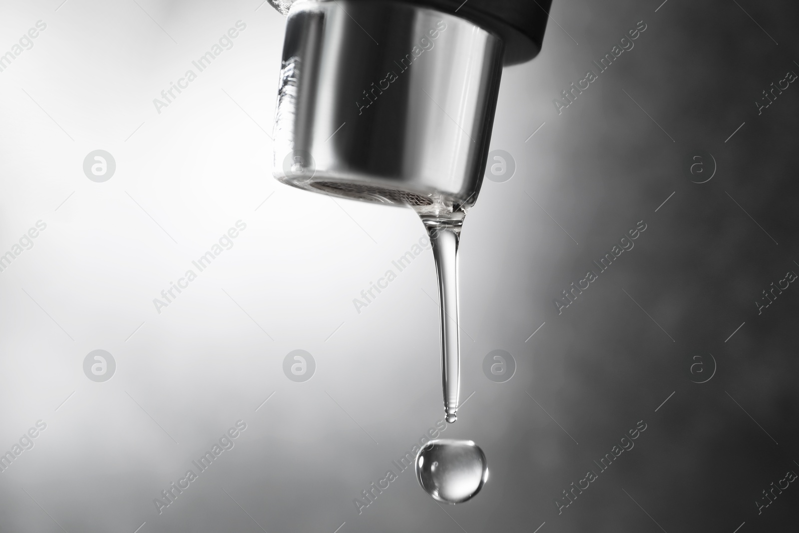 Water dripping down from faucet on grey background, closeup. Space for text Photo of Water dripping down from faucet on grey background, closeup. Space for text