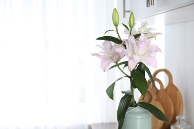 Photo of Beautiful lily flowers in can used as vase at home, space for text