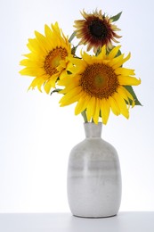 Photo of Beautiful sunflowers in vase on white background