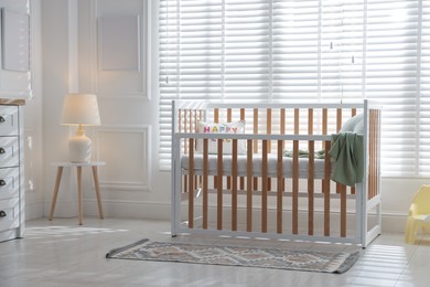 Photo of Stylish baby's room with crib. Interior design