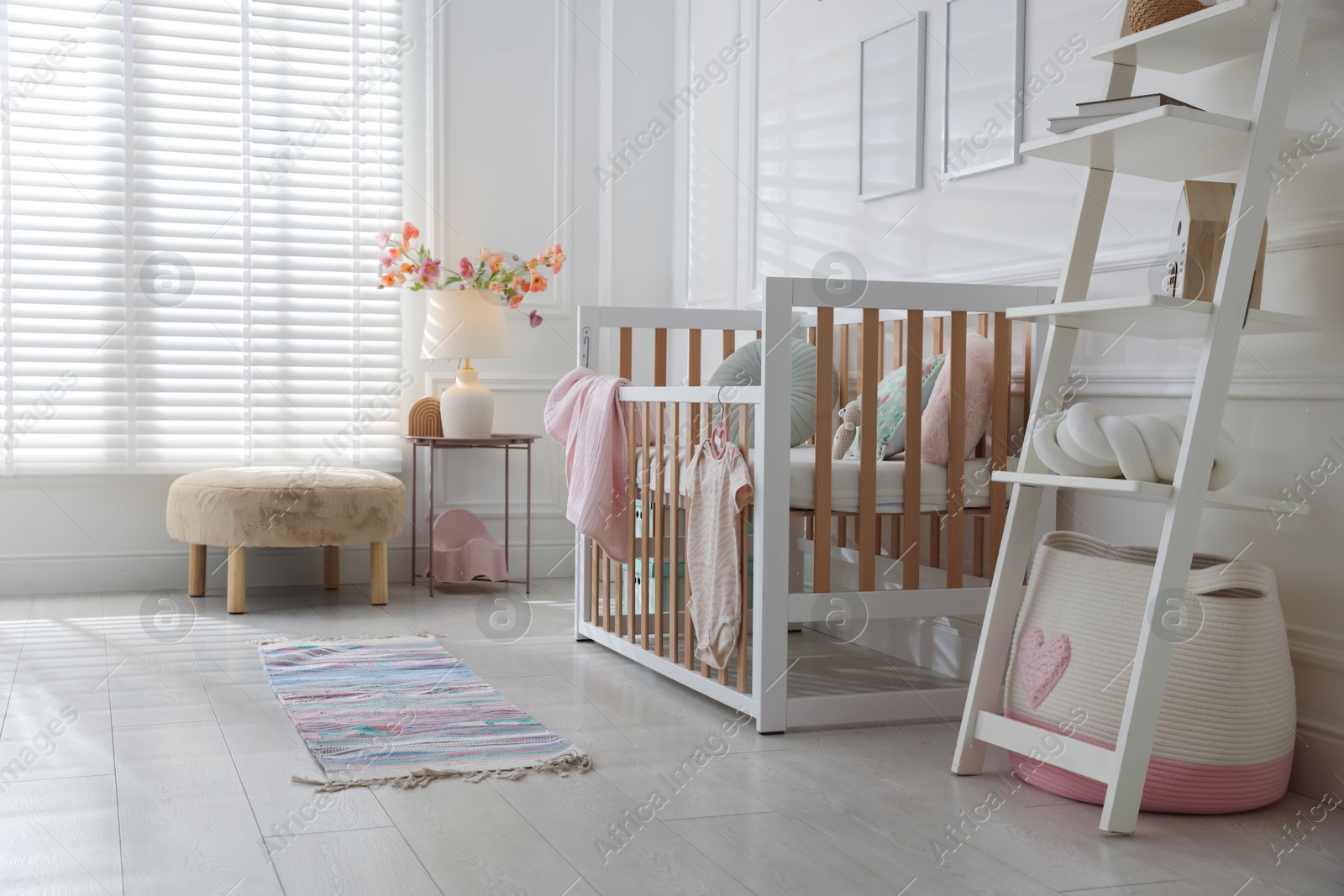 Photo of Stylish baby's room with crib. Interior design