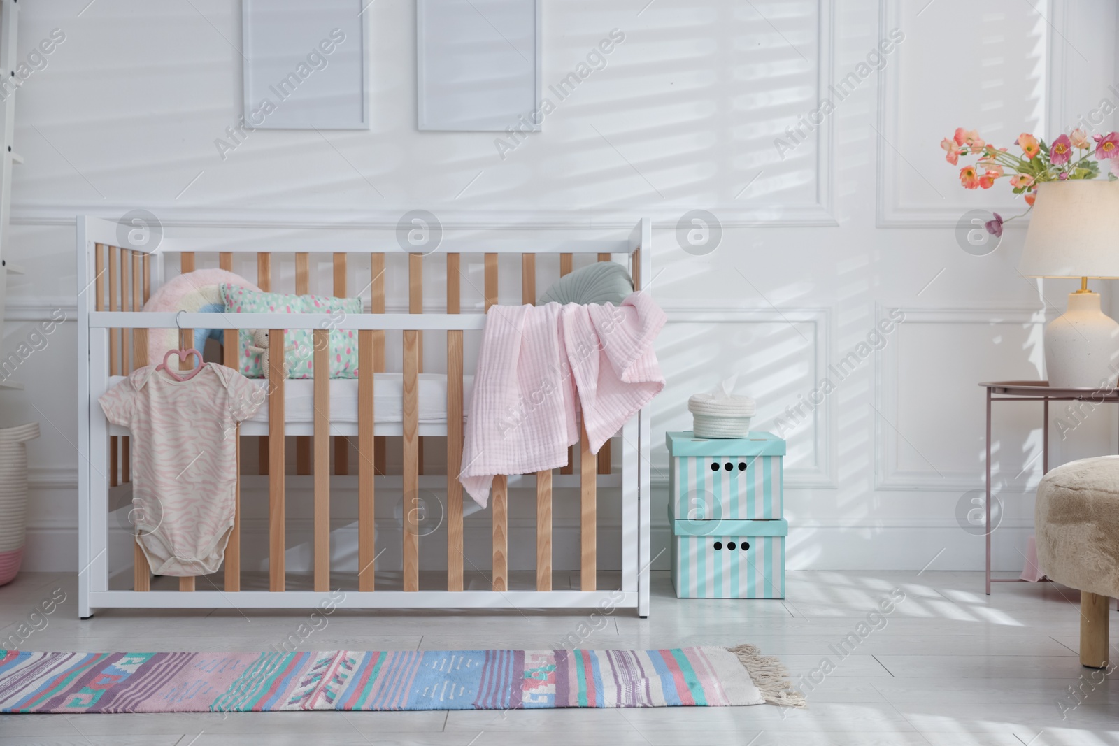 Photo of Stylish baby's room with crib. Interior design