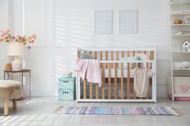 Photo of Stylish baby's room with crib. Interior design