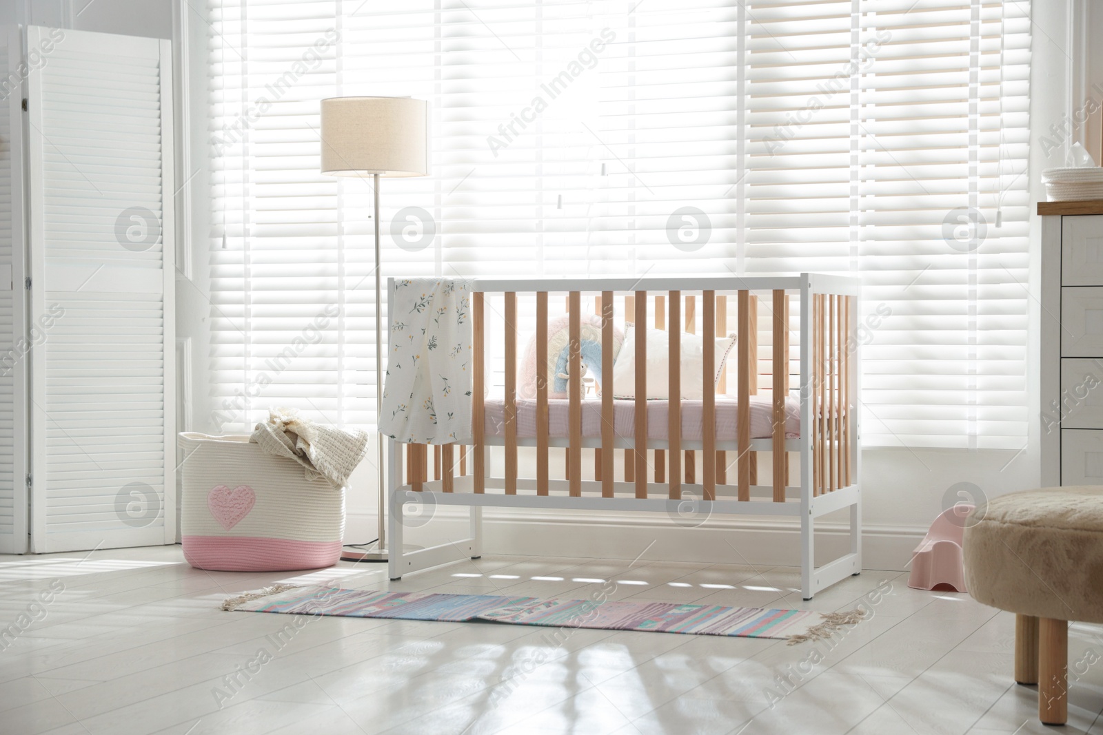 Photo of Stylish baby's room with crib. Interior design