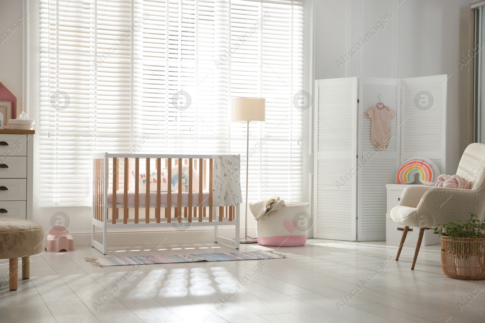 Photo of Stylish baby's room with crib. Interior design