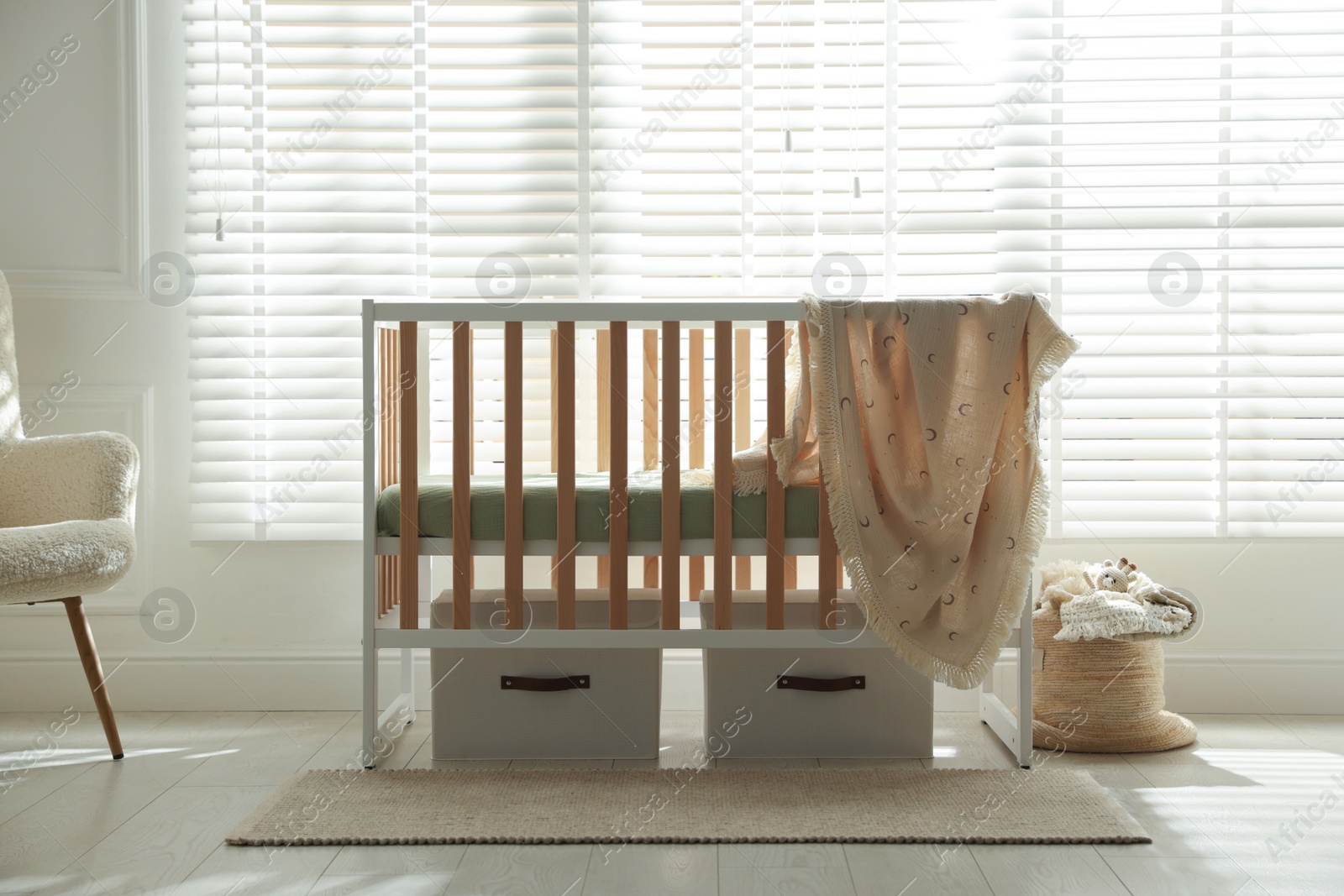 Photo of Stylish baby's room with crib. Interior design
