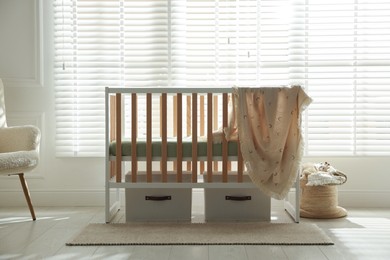 Photo of Stylish baby's room with crib. Interior design