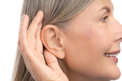 Photo of Sound. Senior woman showing hand to ear gesture on white background, closeup