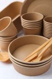 Photo of Set of disposable tableware on white table, closeup